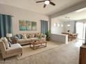 Inviting living room with neutral tones, ceiling fan, natural light, and an open concept floor plan at 17545 W Canyon Ln, Goodyear, AZ 85338
