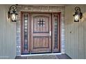 Close-up of an ornate wood front door at 260 E Estero Ln, Litchfield Park, AZ 85340