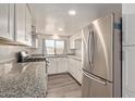 Modern kitchen with white cabinets and granite counters at 305 W 9Th St, Casa Grande, AZ 85122