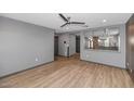 Open concept living area with wood-look floors and kitchen view at 3245 W Melvin St, Phoenix, AZ 85009