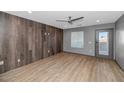 Bright living room featuring wood-look floors and a door to patio at 3245 W Melvin St, Phoenix, AZ 85009