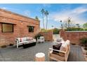 Relaxing patio area with brick walls, comfortable seating, and fire pit at 3807 N 55Th Pl, Phoenix, AZ 85018