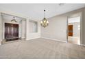 Spacious dining room with a chandelier and neutral colored walls at 38724 N Donovan Ln, Anthem, AZ 85086