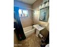 Clean bathroom with a pedestal sink and shower/tub combo at 5016 S 20Th Pl, Phoenix, AZ 85040