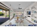 Bright living room with sliding glass doors, custom built-ins, and a ceiling fan at 5026 W Parsons Rd, Phoenix, AZ 85083