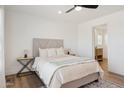 Comfortable bedroom features a neutral color palette, plush bedding, and an ensuite bathroom at 53212 W Barn Owl Rd, Maricopa, AZ 85139