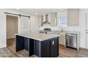 Modern kitchen featuring an island, stainless steel appliances, and light cabinets at 53212 W Barn Owl Rd, Maricopa, AZ 85139