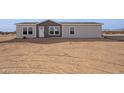 New manufactured home with neutral exterior and desert landscaping at 53259 W Barn Owl Rd, Maricopa, AZ 85139