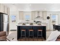 Modern kitchen with island, stainless steel appliances, and marble countertops at 53259 W Barn Owl Rd, Maricopa, AZ 85139