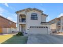 Two-story house with balcony, attached garage, and landscaping at 5341 E Carol Ave, Mesa, AZ 85206
