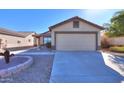 House exterior showcasing a garage and desert landscaping at 639 W Kingman Loop, Casa Grande, AZ 85122