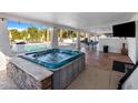 Relaxing hot tub with tiled surround near the pool at 6542 E Ludlow Dr, Scottsdale, AZ 85254