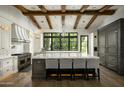 Gourmet kitchen featuring a large island, high-end appliances, and exposed wooden beams at 7305 E Royal Palm Rd, Scottsdale, AZ 85258