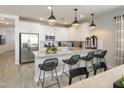 Modern kitchen with stainless steel appliances and island at 8058 E Petra Ave, Mesa, AZ 85212