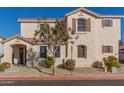 Two-story house with tan exterior, landscaped yard, and two-car garage at 832 E Stottler Dr, Gilbert, AZ 85296