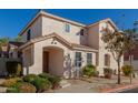 Two-story house with tan exterior, landscaped yard, and two-car garage at 832 E Stottler Dr, Gilbert, AZ 85296