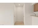 Bright hallway with light wood floors and doors at 10610 S 48Th St # 2089, Phoenix, AZ 85044