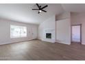 Spacious living room showcasing a white brick fireplace and vinyl plank flooring at 110 W San Pedro Ave, Gilbert, AZ 85233