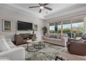 Spacious living room with modern furniture and large TV at 14571 W Wethersfield Rd, Surprise, AZ 85379