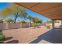 Covered patio area with desert landscaping at 19810 N 90Th Ln, Peoria, AZ 85382