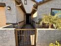 Front entry with stone accents and wrought-iron gate at 2074 N 139 Dr, Goodyear, AZ 85395