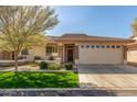 Single-story home with a two-car garage and nicely landscaped front yard at 2663 S Springwood Blvd # 311, Mesa, AZ 85209