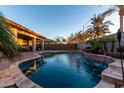 Inviting kidney-shaped pool with water features and a large patio at 3222 S 186Th Ln, Goodyear, AZ 85338