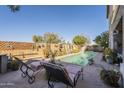 Inviting backyard oasis featuring a sparkling pool and comfortable lounge chairs at 32974 N Madison Way Dr, San Tan Valley, AZ 85144