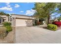 Attached two-car garage with stone exterior at 3830 E Carter Dr, Phoenix, AZ 85042