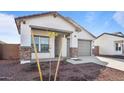 New construction home with a two-car garage and desert landscaping at 3873 S 233Rd Ln, Buckeye, AZ 85326