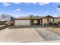 House with a two-car garage and a spacious driveway at 4641 W Palo Verde Ave, Glendale, AZ 85302