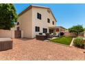 Backyard with artificial turf, patio cover, and seating area at 62 W Melody Dr, Gilbert, AZ 85233