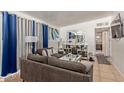 Living room with a sofa, decorative tables, and access to other rooms at 633 W 1St St, Mesa, AZ 85201