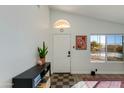 Bright and airy entryway with a checkerboard floor and a console table at 6436 E Virginia St, Mesa, AZ 85215