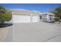 Three car garage and front view of a single story home at 7278 W Via Montoya Dr, Glendale, AZ 85310