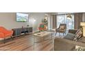 Living room with comfortable seating and a large flat-screen TV at 7625 E Camelback Rd # B148, Scottsdale, AZ 85251