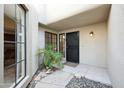 Private courtyard entry with black wrought-iron door and tile flooring at 8881 E Meadow Hill Dr, Scottsdale, AZ 85260