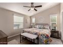 Spacious bedroom with a king-size bed and floral bedding at 9333 E University Dr # 110, Mesa, AZ 85207
