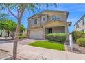 Inviting two-story home with a tidy lawn, neutral colors and a two-car garage at 9839 E Theia Dr, Mesa, AZ 85212