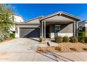 Modern single story home with gray siding, white accents and a covered porch at 10032 E Toledo Ave, Mesa, AZ 85212