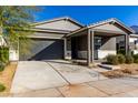 Modern single story home with gray siding, white accents and a covered porch at 10032 E Toledo Ave, Mesa, AZ 85212