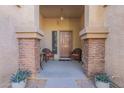 Covered entryway with brick columns and seating area at 1227 W Delmonte Dr, Casa Grande, AZ 85122