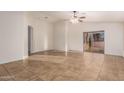 Spacious living room with tile flooring and a ceiling fan at 14033 W Two Guns Trl, Surprise, AZ 85374