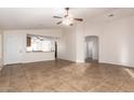 Living room with tile floors, high ceilings, and an open floor plan at 14033 W Two Guns Trl, Surprise, AZ 85374