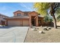 Two-story house with a three-car garage and nicely landscaped front yard at 1440 S Central Dr, Chandler, AZ 85286