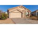 Tan one-story house with two-car garage and desert landscaping at 14529 N 87Th Dr, Peoria, AZ 85381