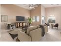 Spacious living room with vaulted ceiling and staged furniture at 14529 N 87Th Dr, Peoria, AZ 85381