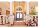 Two-story entryway with a staircase and double doors at 15225 N Bluejay Pl, Fountain Hills, AZ 85268