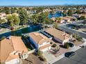 Aerial view of two-story home by the lake with neighboring houses at 1610 W Maplewood St, Chandler, AZ 85286