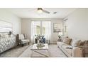 Spacious living room featuring a comfortable sofa, stylish decor, and large windows at 1693 E Dogwood Ln, Gilbert, AZ 85295